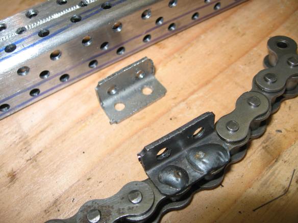 A 1x1 inch steel tube with 4mm holes every half inch, cut into quarters makes WA-2 chain attachments, which can be welded to the chain pins.